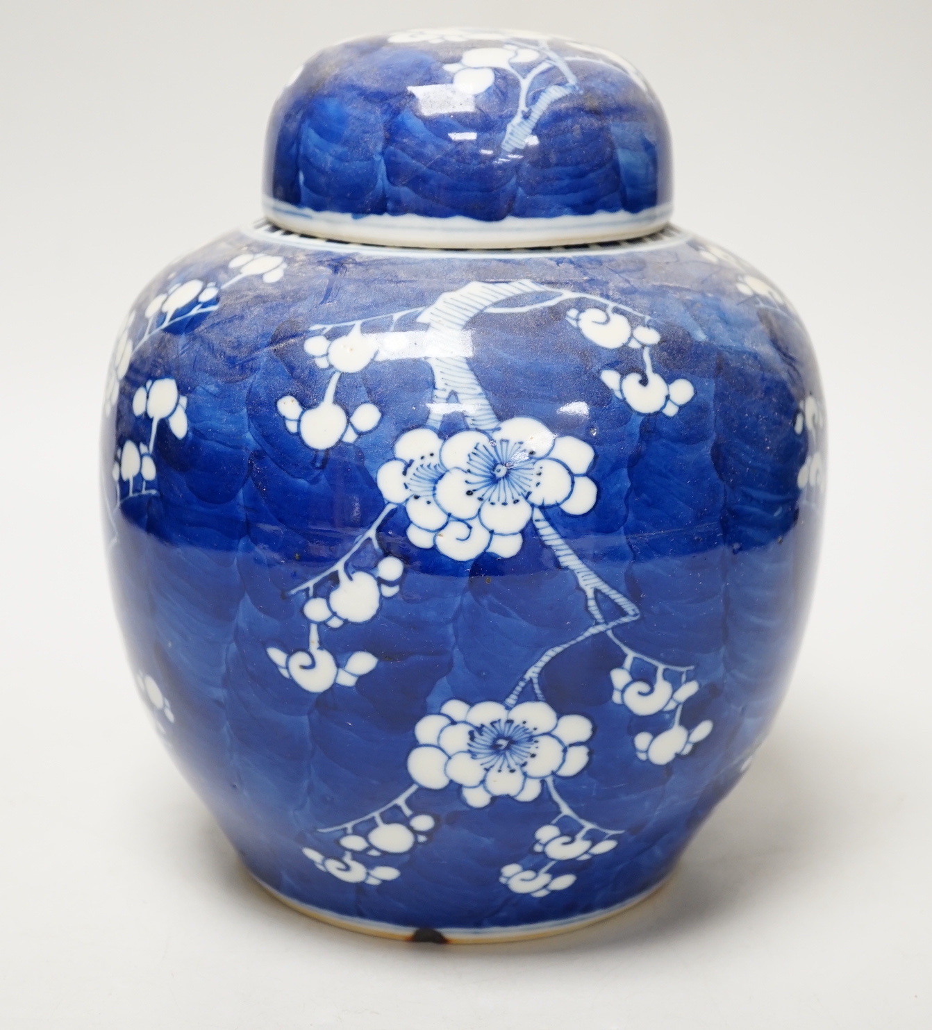 A 19th/20th century Chinese blue and white prunus jar and cover, 22cm